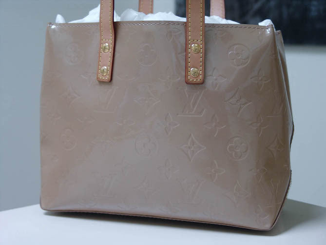 Louis Vuitton Reade PM in Beige Monogram Vernis. A few marks as